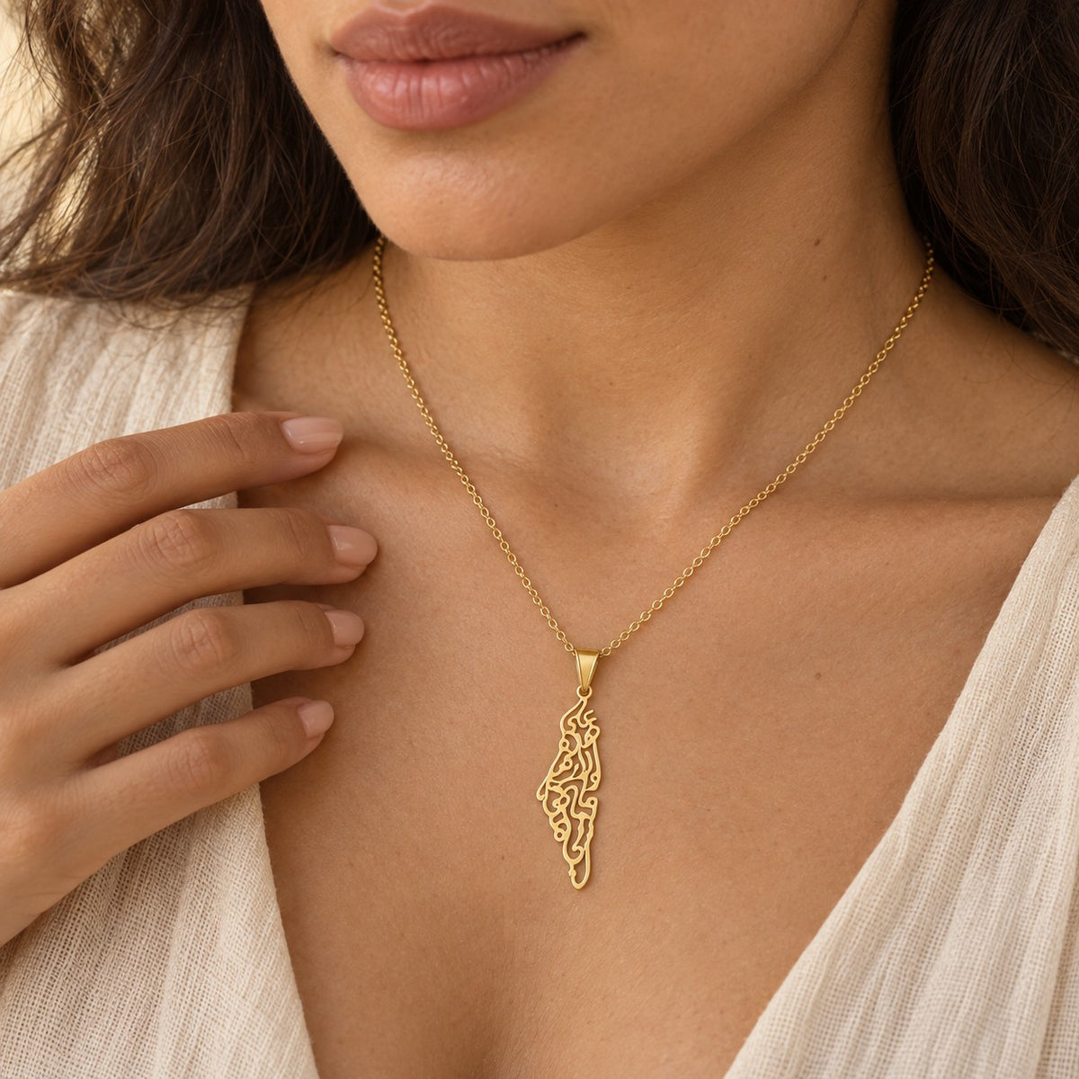 The Palestine Calligraphy Map Necklace worn, showing its true size