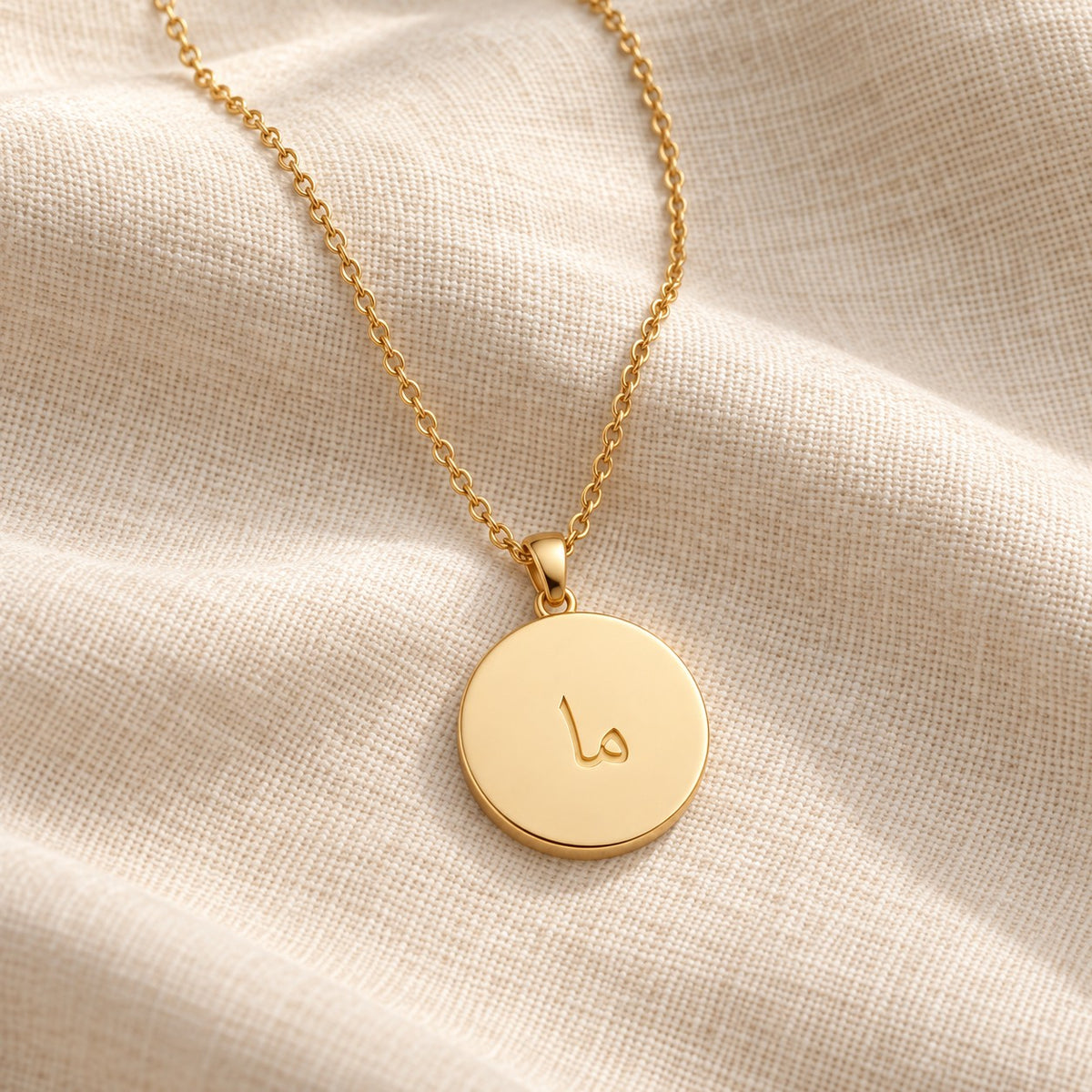 Arabic Initial Pendant Necklace 18k on cream linen