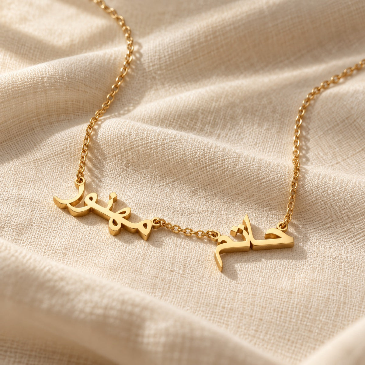 Wasl Arabic Multiple Name Necklace on cream linen