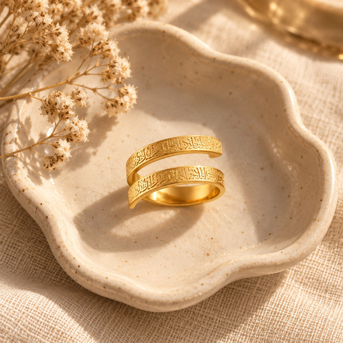 The Ayatul Kursi Spiral Ring in a ceramic trinket dish