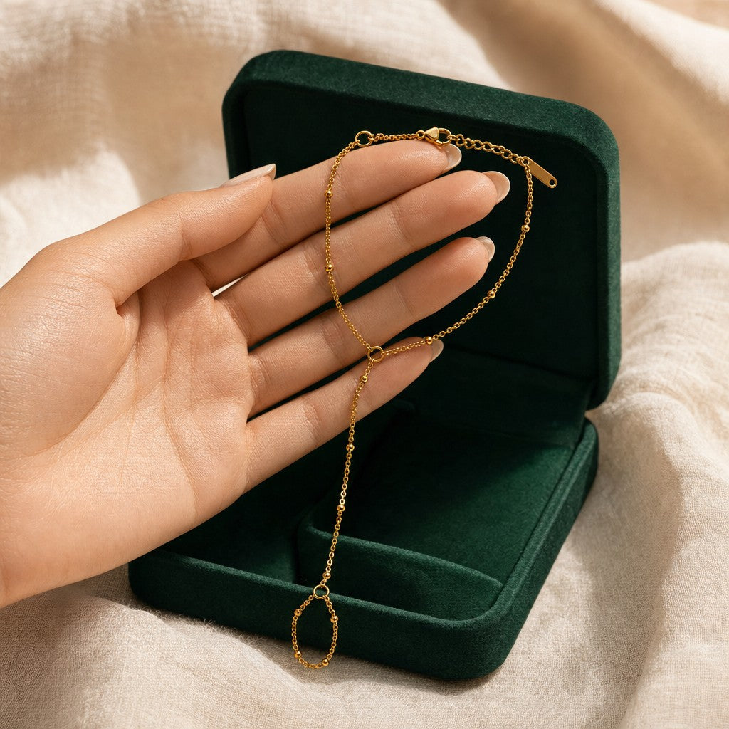 Dotted Hand Chain presented in an emerald velvet gift box