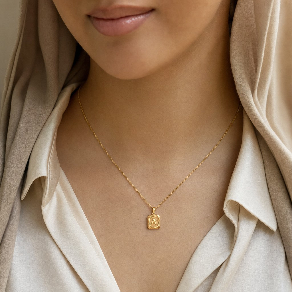 Woman wearing the Medallion Initial Necklace