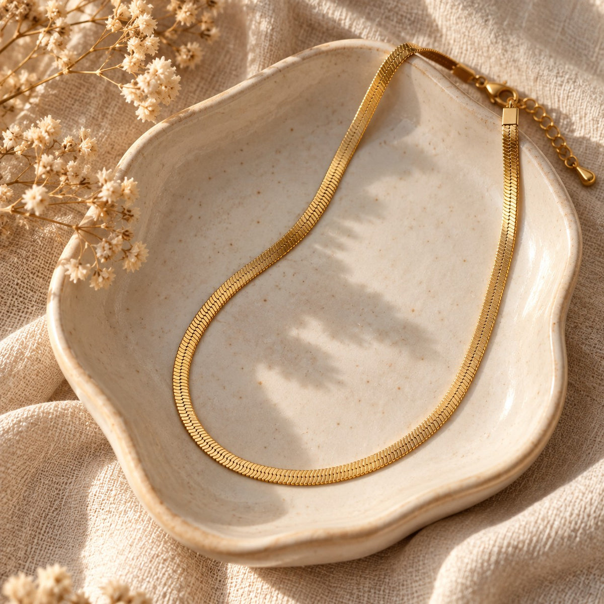 The Aura Herringbone in a ceramic trinket dish