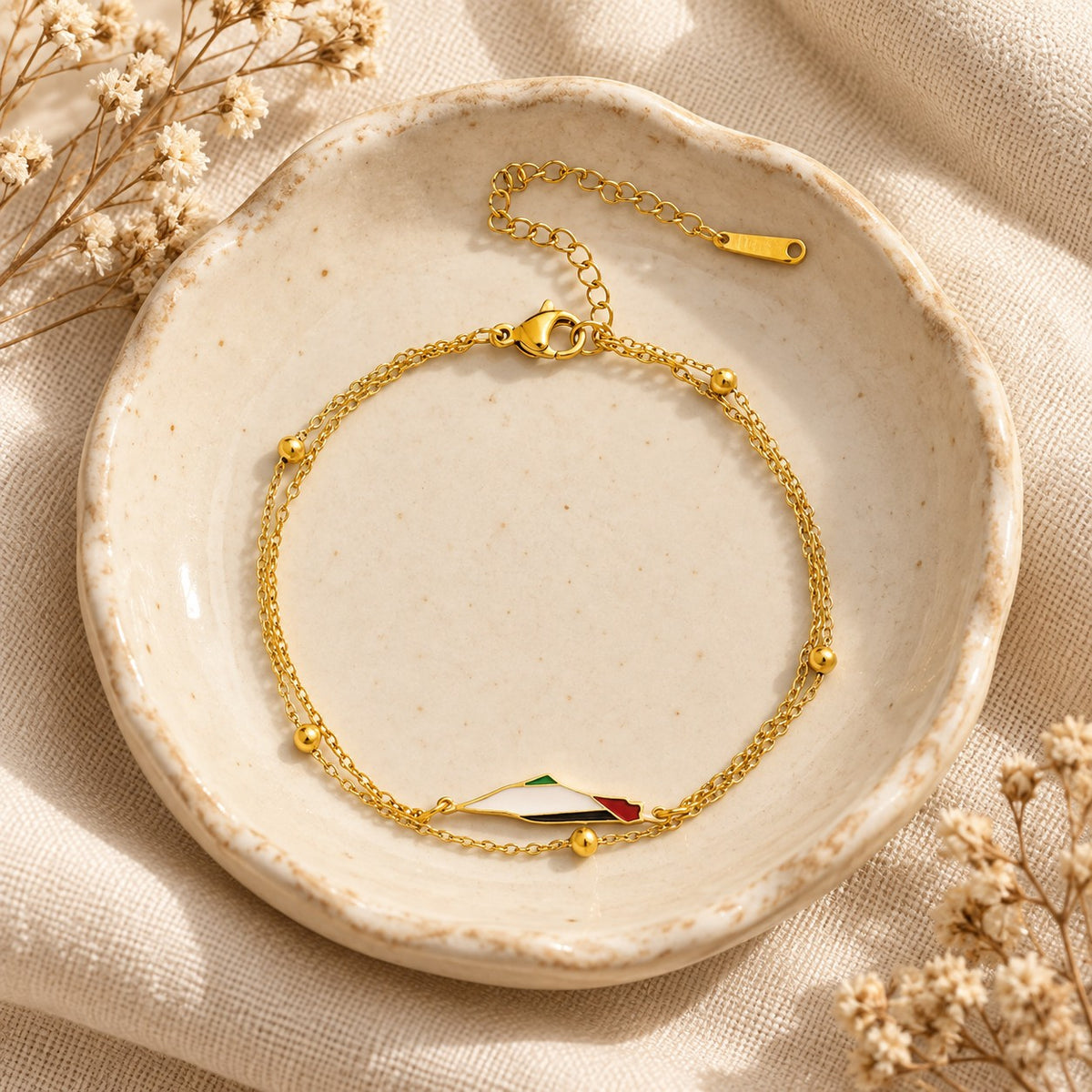 The Palestine Map Bracelet in a ceramic trinket dish