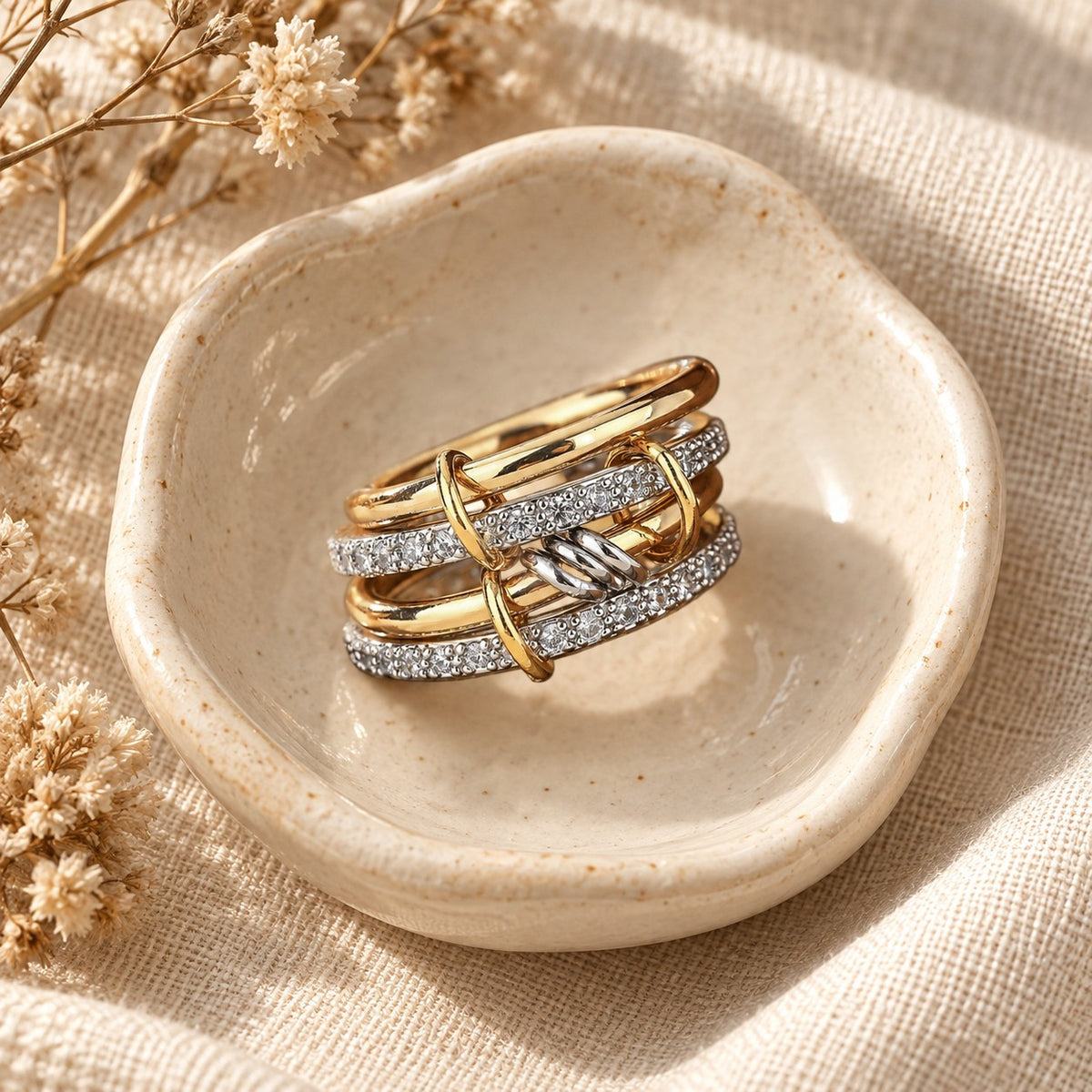 The Sabr Stack Ring in a ceramic trinket dish
