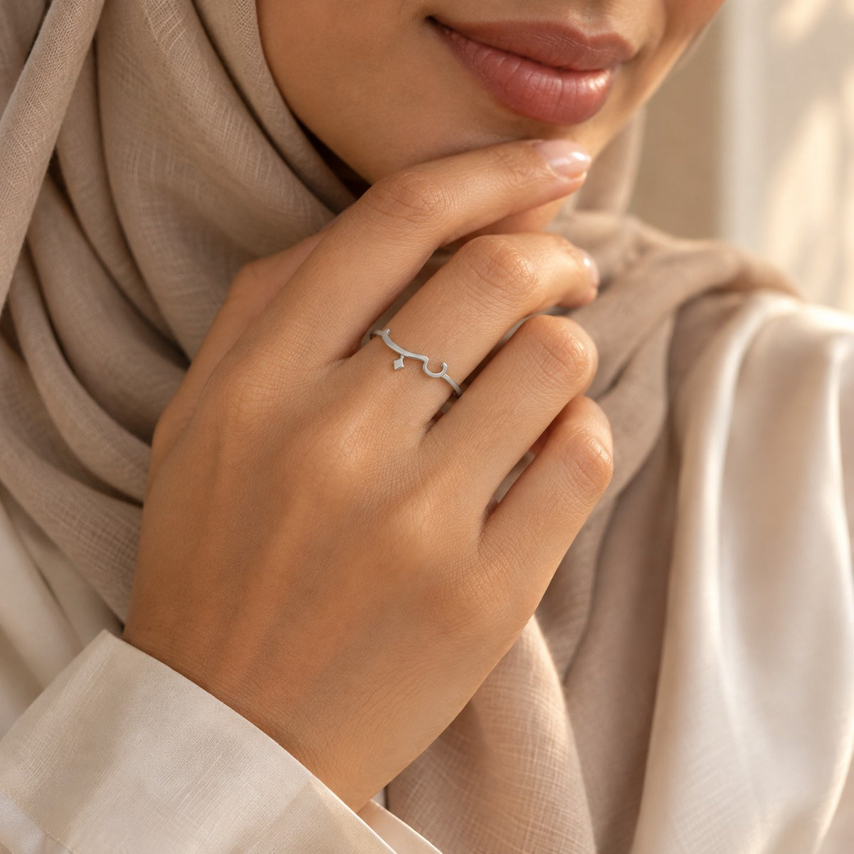 Woman wearing the Arabic Love Ring in silver